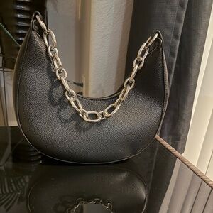 Black crescent bag with silver chain shoulder strap
